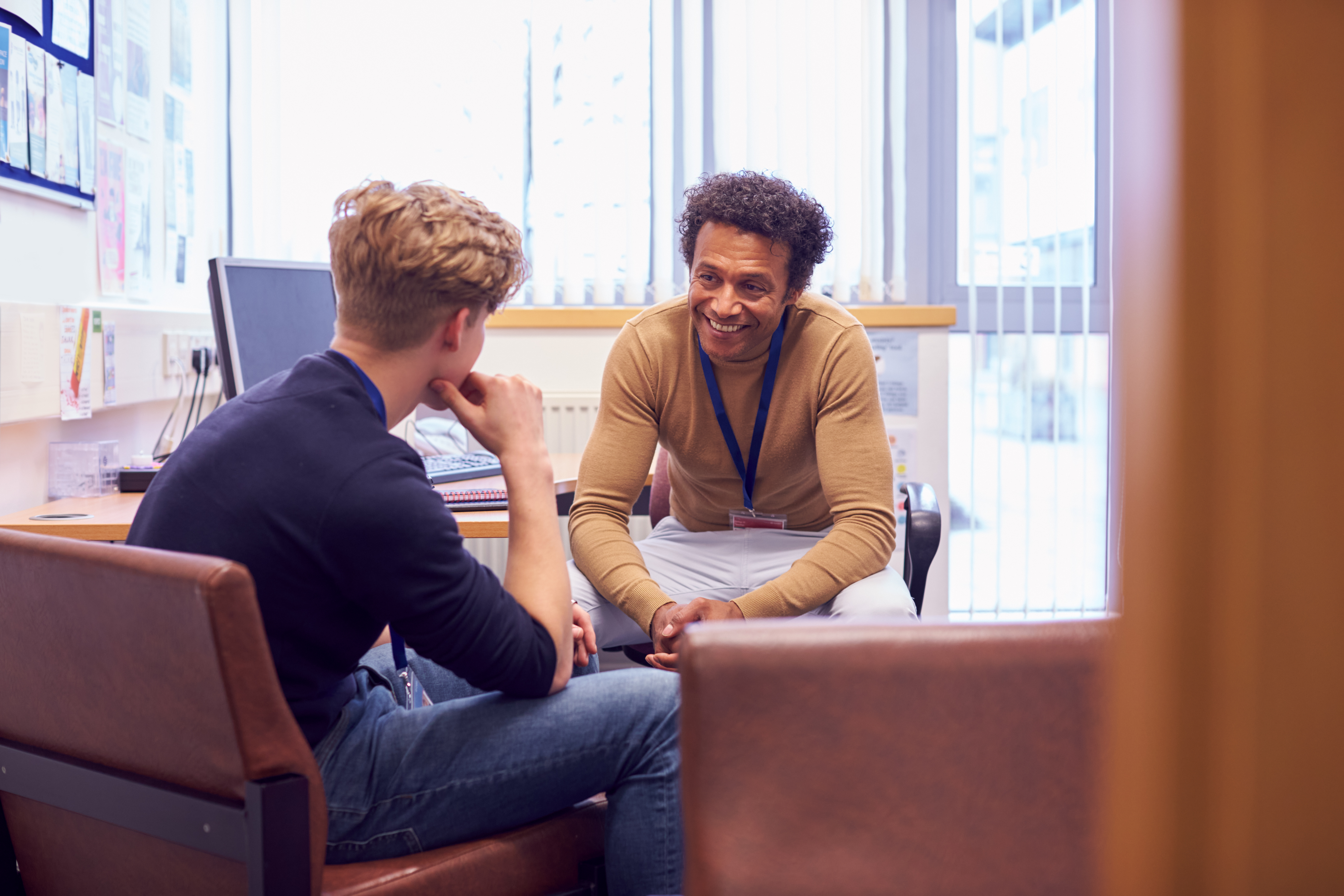 Male counselor meeting with a student